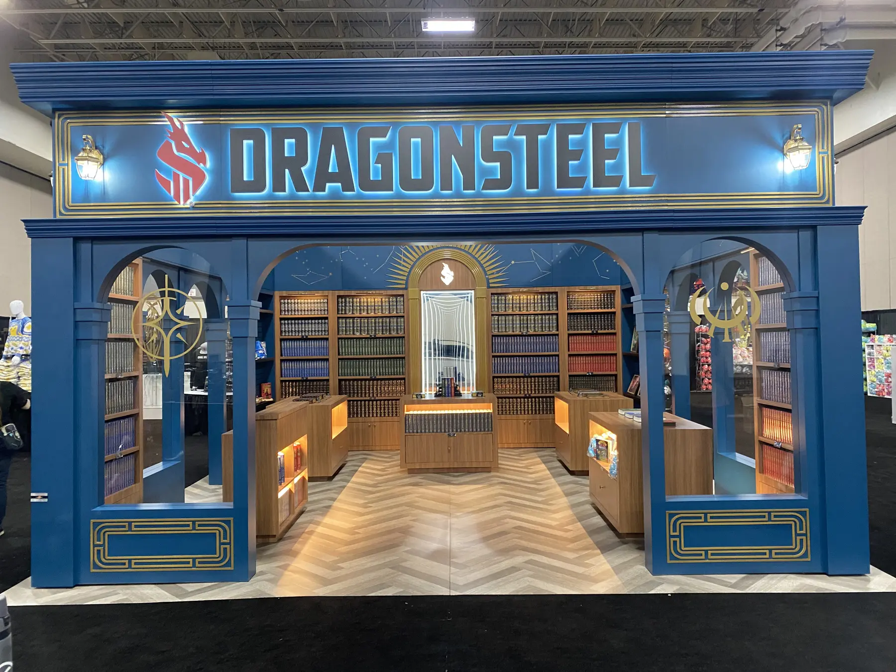 Front view of the blue Dragonsteel exhibit with arched entry and merchandise displays