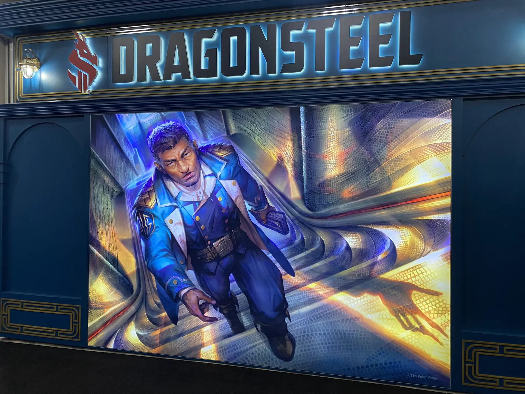 Large illustrated character graphic on the side wall of the Dragonsteel exhibit